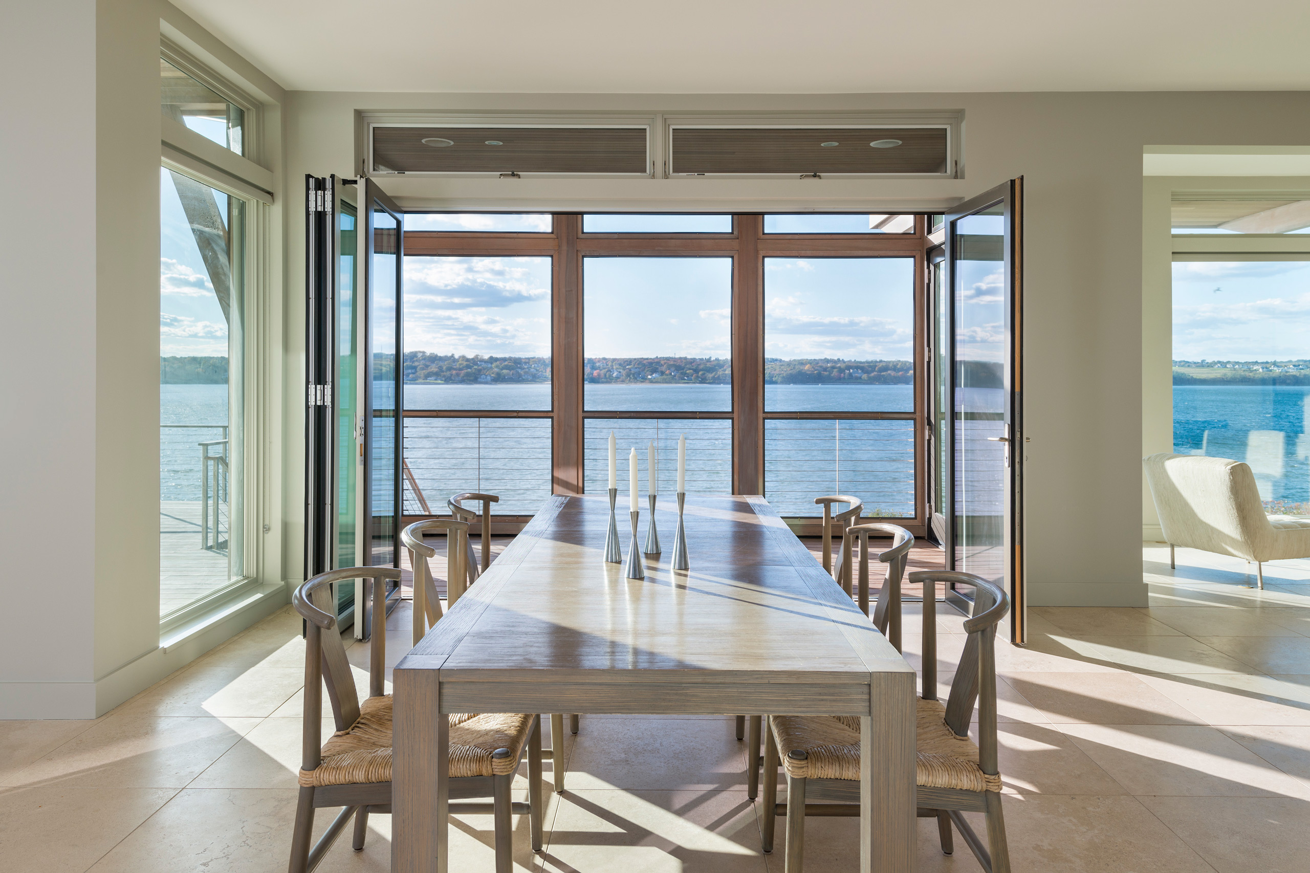Dining area opens to screened porch with water views
