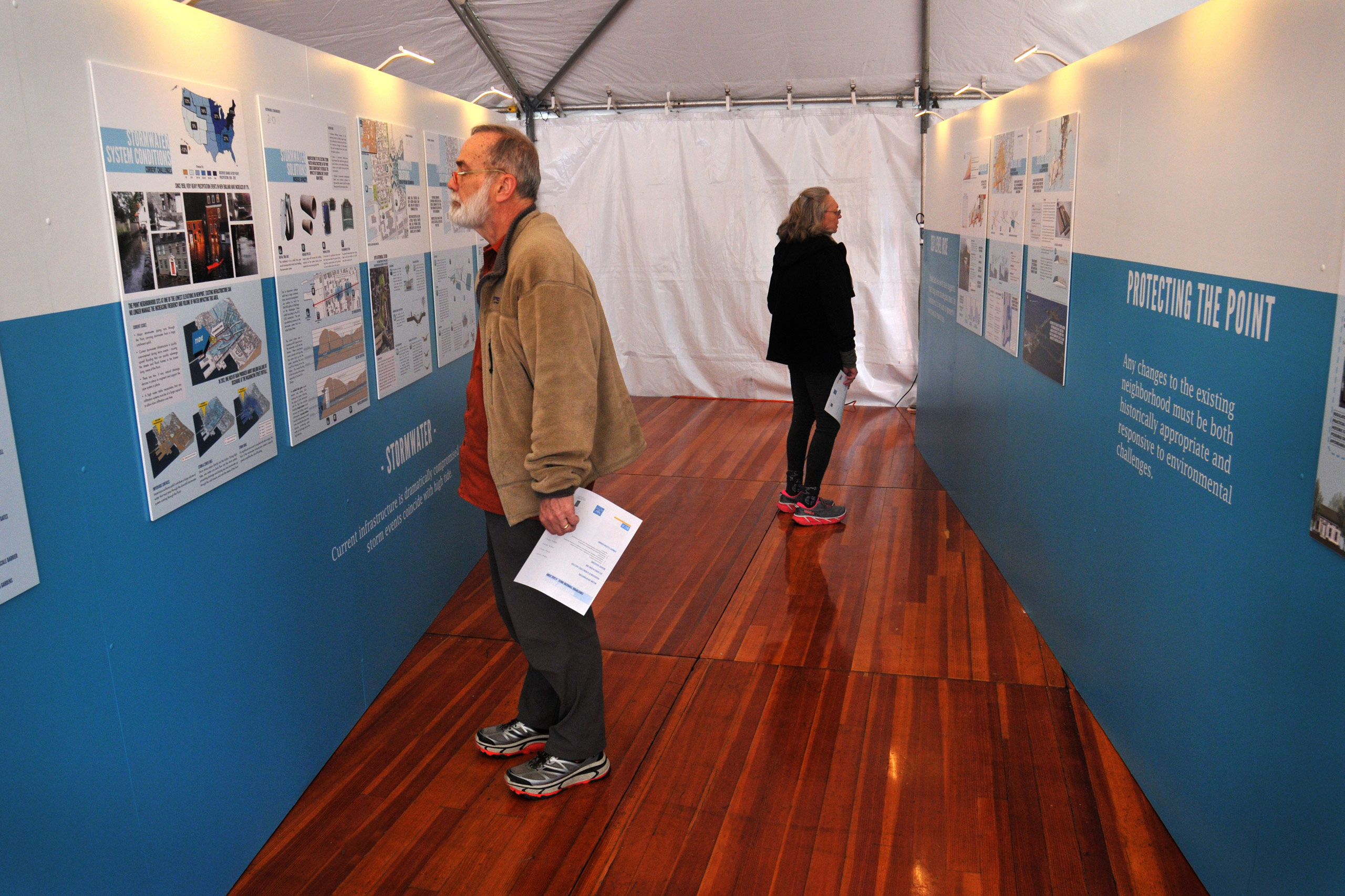 Residents viewing 26-panel exhibit